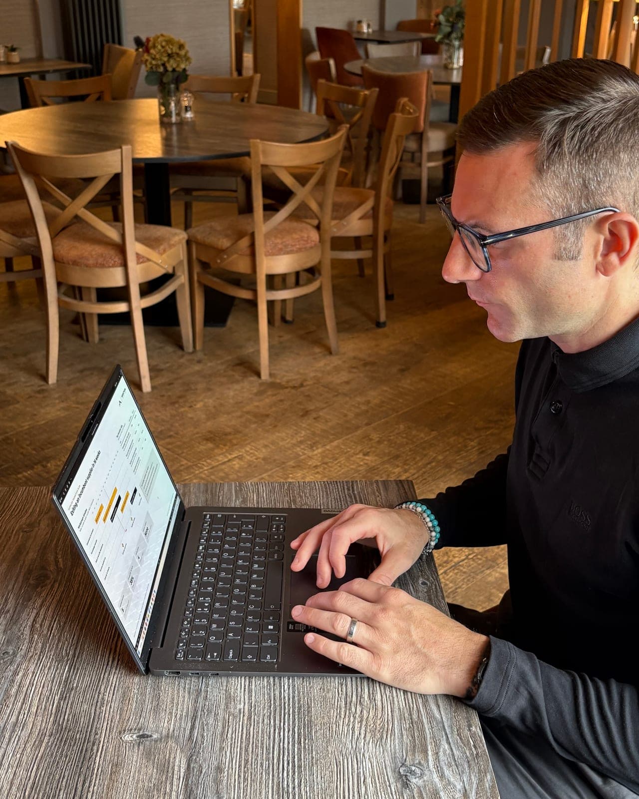 Greg Spanner reviewing a performance dashboard on his laptop (illustrative data)